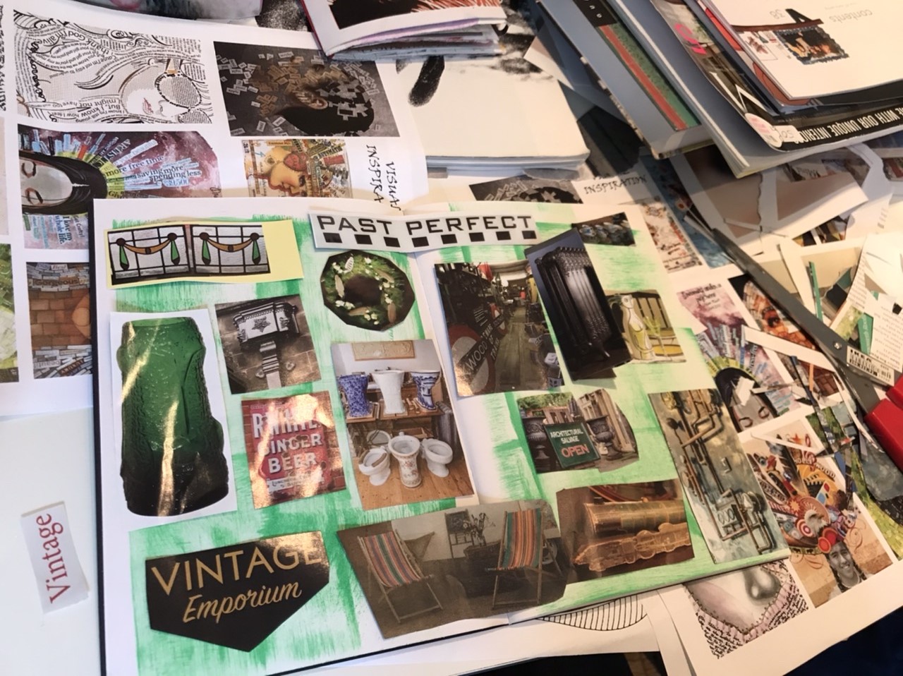 A photo from one of the taster workshops. For this workshop, the group were trying art journalling. In this photo, a table is covered in magazines and collages.